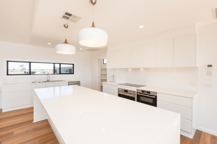 A sleek, white kitchen in a custom Swanbuild home