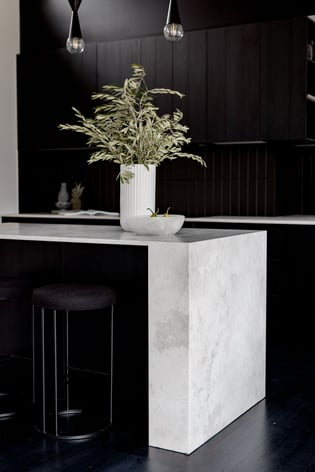 White stone benchtop in black kitchen