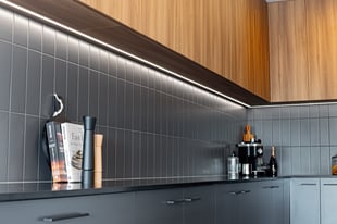 black kitchen with under cabinet lighting